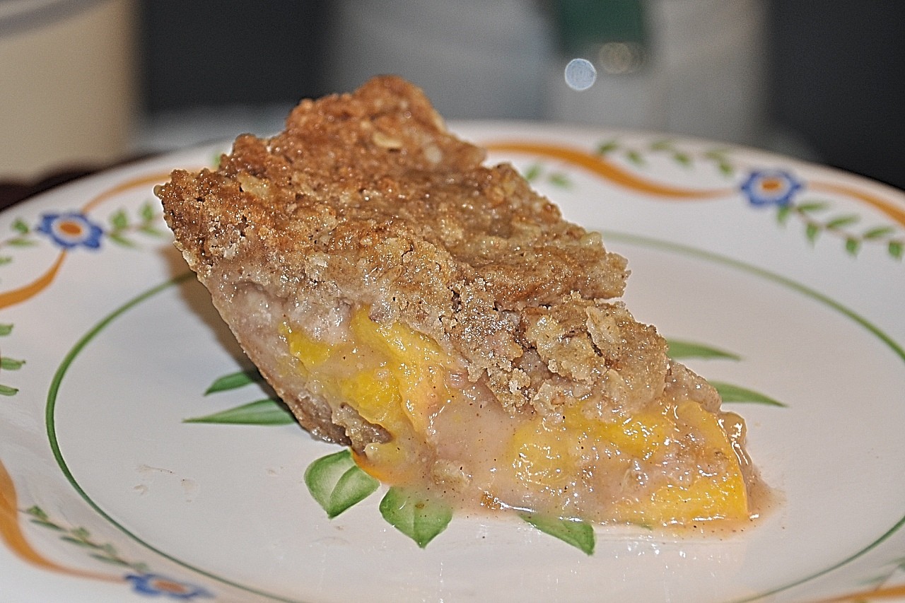 Frest peach pie spiced with cinnamon, nutmeg, ginger, and lemon zest make for an unforgettable pie treat. Add sweet and nutty crust and crumble for flavor.