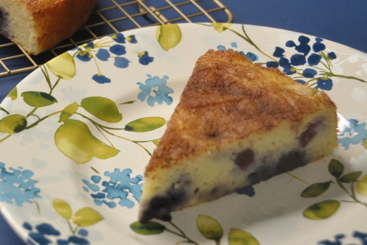 Super moist single layer cake made with lemon and blueberries and topped with cinnamon sugar.