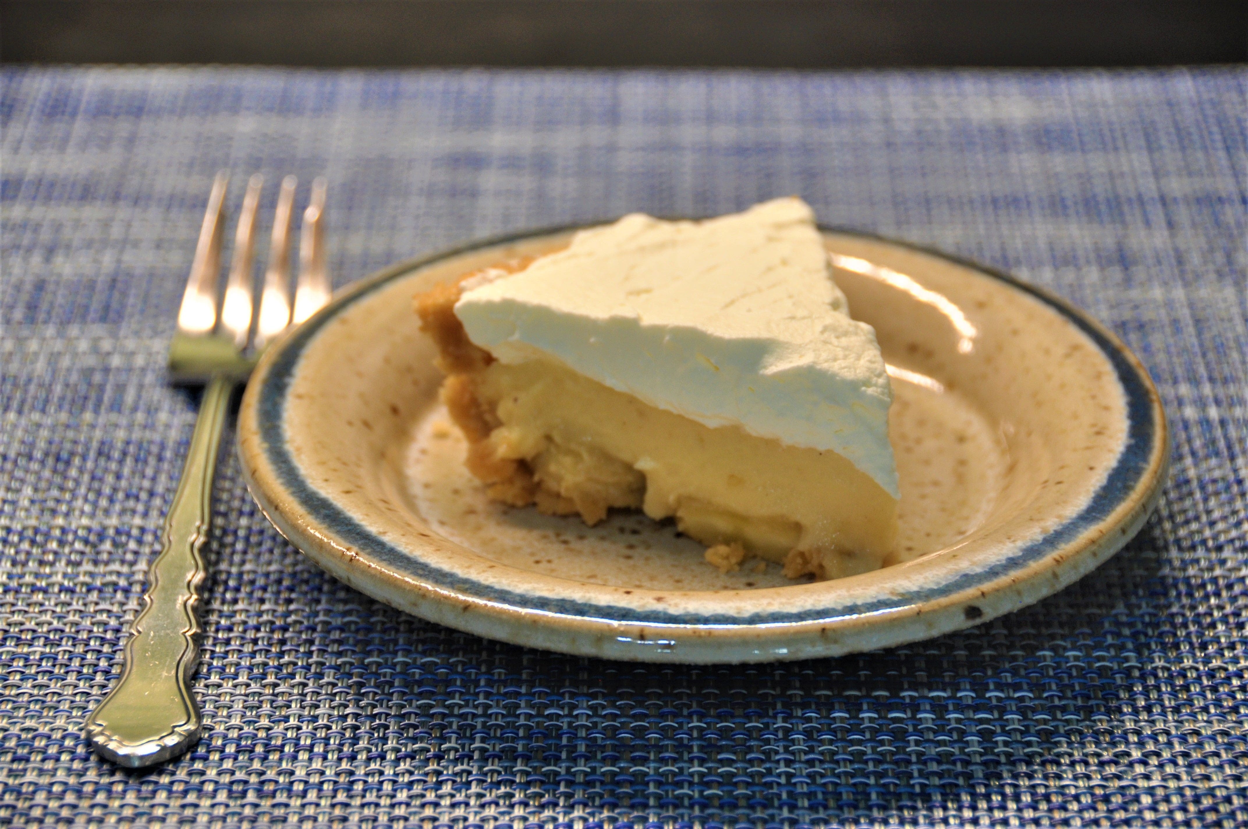 Banana pudding in a cookie crumb crust and layerd with fresh banana and whipped cream.