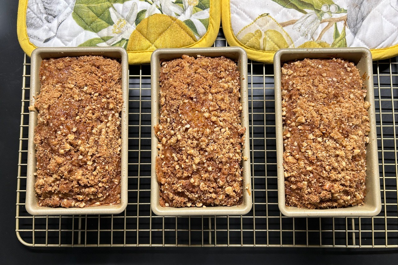 A trio of walnut, cranberry, and apple pumpkin breads fresh from the oven.