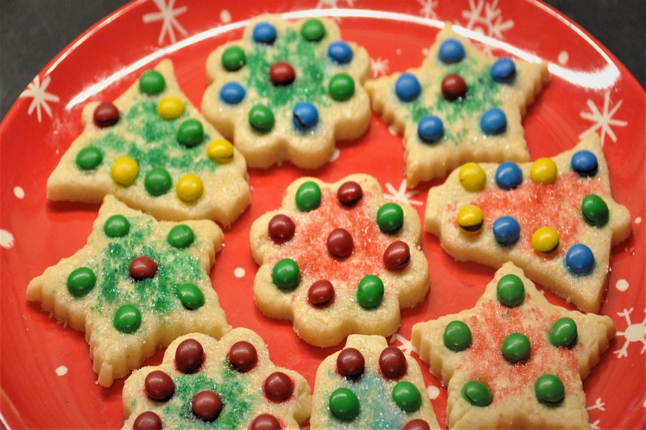 Orange flavored sugar cookies decorated with M&M candies and dusted with sanding sugar.