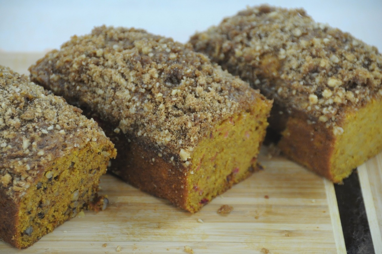 A trio of walnut, cranberry, and apple mini breads with sweet streusel topping.