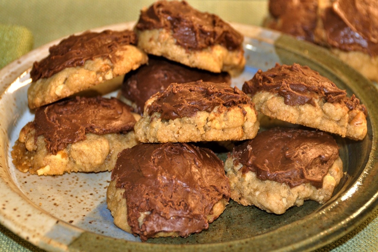 Brown sugar cookies loaded with pecans and topped with thick, sweet chocolate icing.