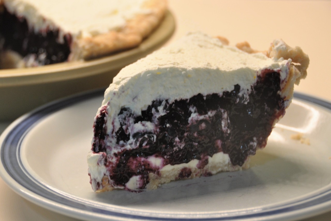 Mix fresh and cooked blueberries, cream cheese, and whipped cream topping for a luscious summer pie.